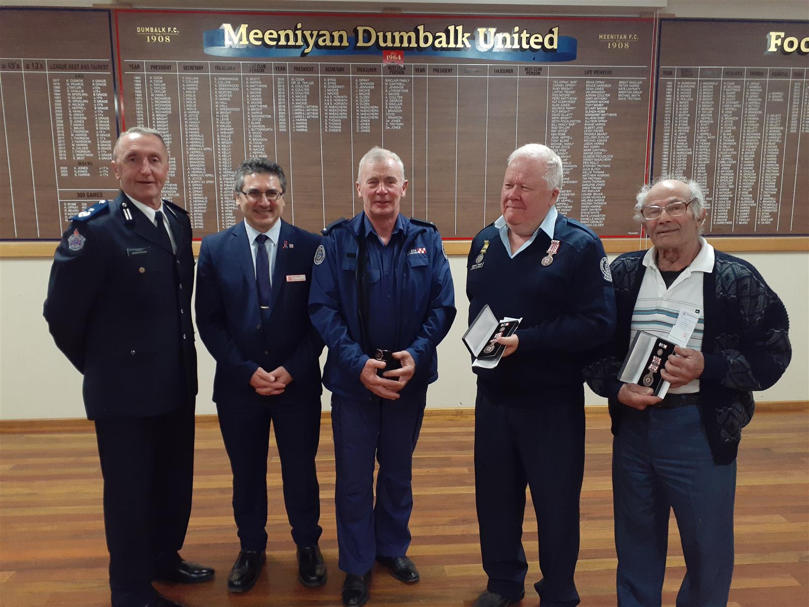 Presenting Dumbalk’s Service Awards were, from left, Commander Andrew McCartney, CFO Sam Costanzo, Captain Dallas Campbell, and recipients Rob Fisher (15 years) and Tony Maruzza (15 years).